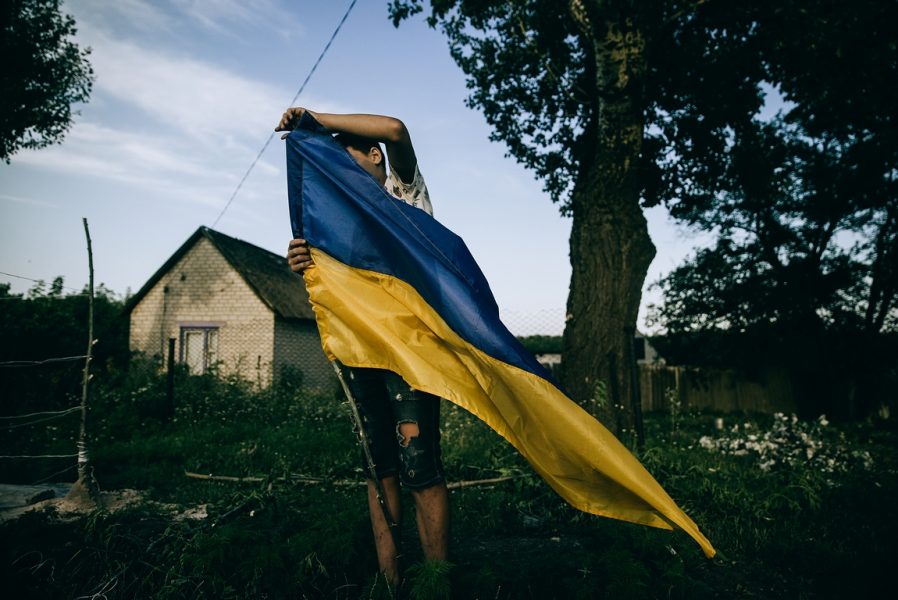 WORLD PRESS PHOTO AWARD OPEN FORMAT War Is Personal. The kid is setting "a checkpint" in Zelene village Kharkiv region. (© Julia Kochetova)